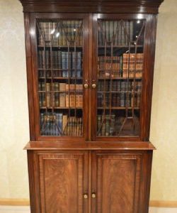 A MAHOGANY REGENCY PERIOD TWO DOOR ANTIQUE BOOKCASE