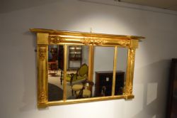 A SMALL GILT WOOD WILLIAM IV PERIOD OVERMANTEL MIRROR.